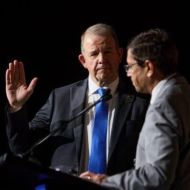 New president, Tom Holland, MD, taking the oath