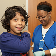 Young hispanic boy getting a vaccine