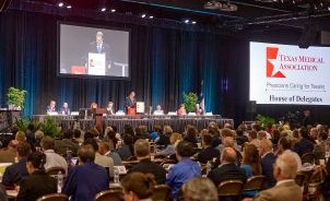 Large group of attendees sitting in the House of Delegates at TexMed